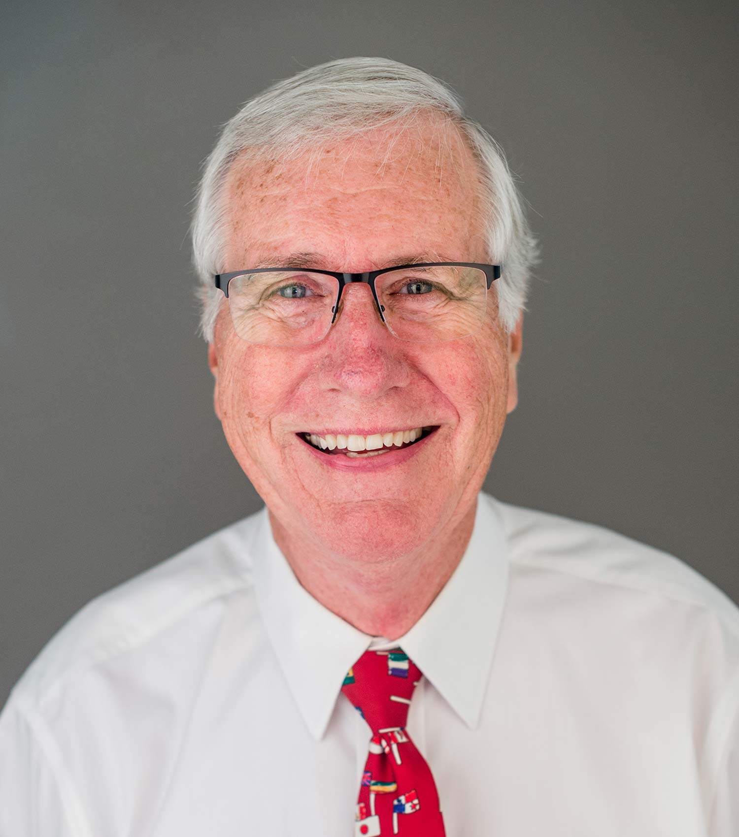 Man wearing glasses and smiling.