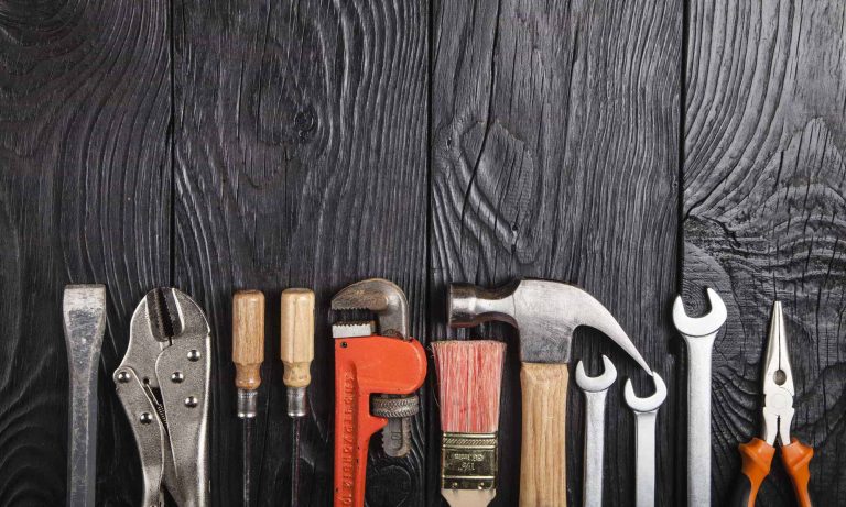 Set of various tools displayed in a neatly arranged collection, possibly within a shop or workshop setting.