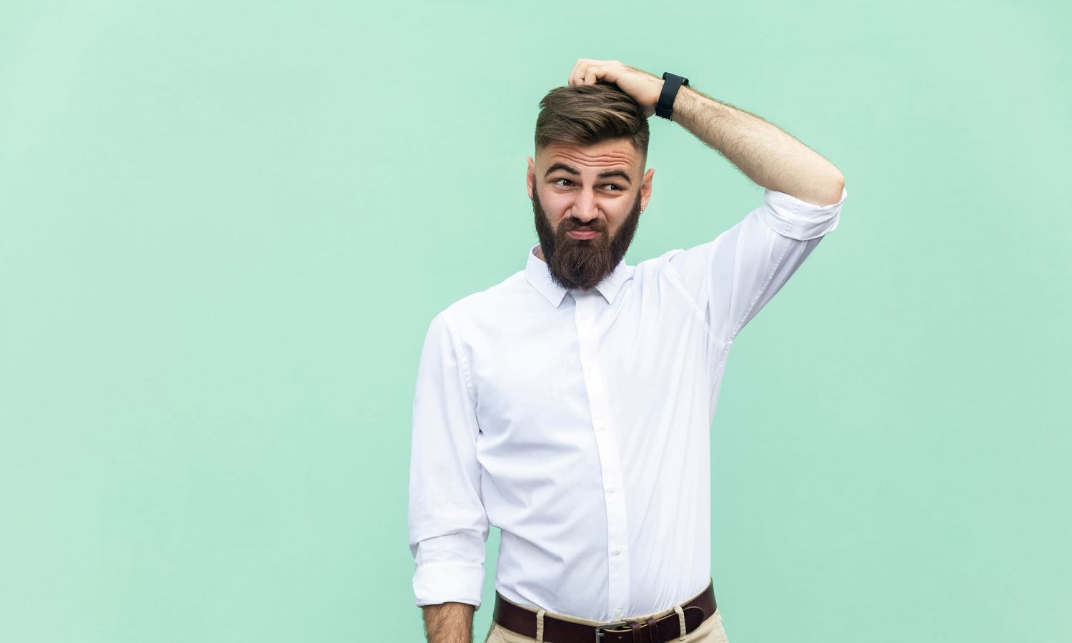 Man posing in front of a blue background.