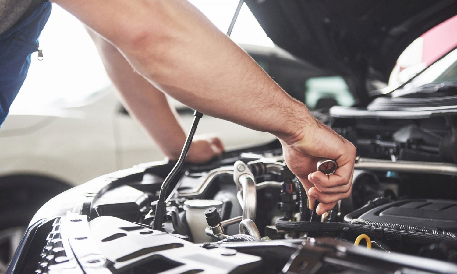 An engine of a car being repaired in a garage.