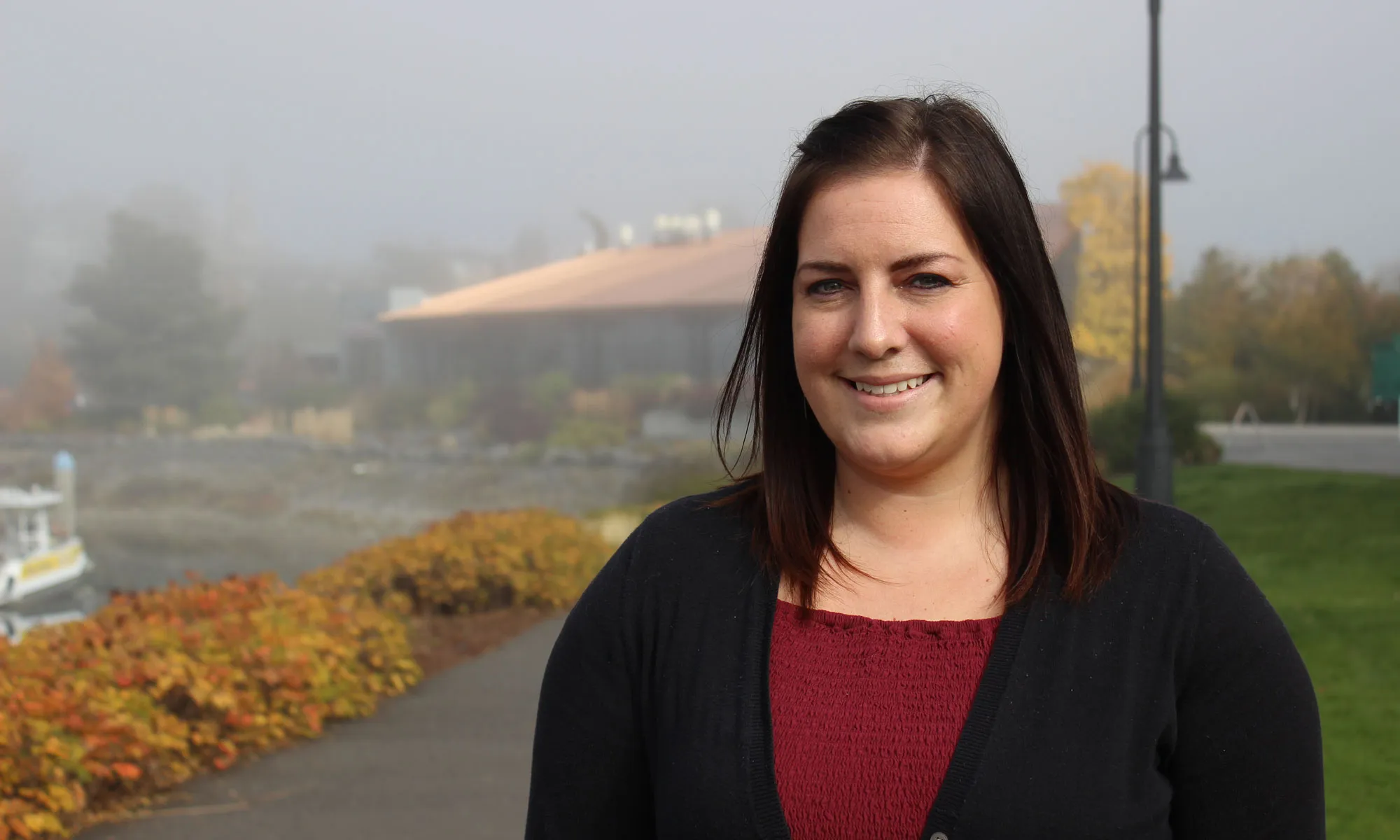 Woman posing for a picture on a foggy day.