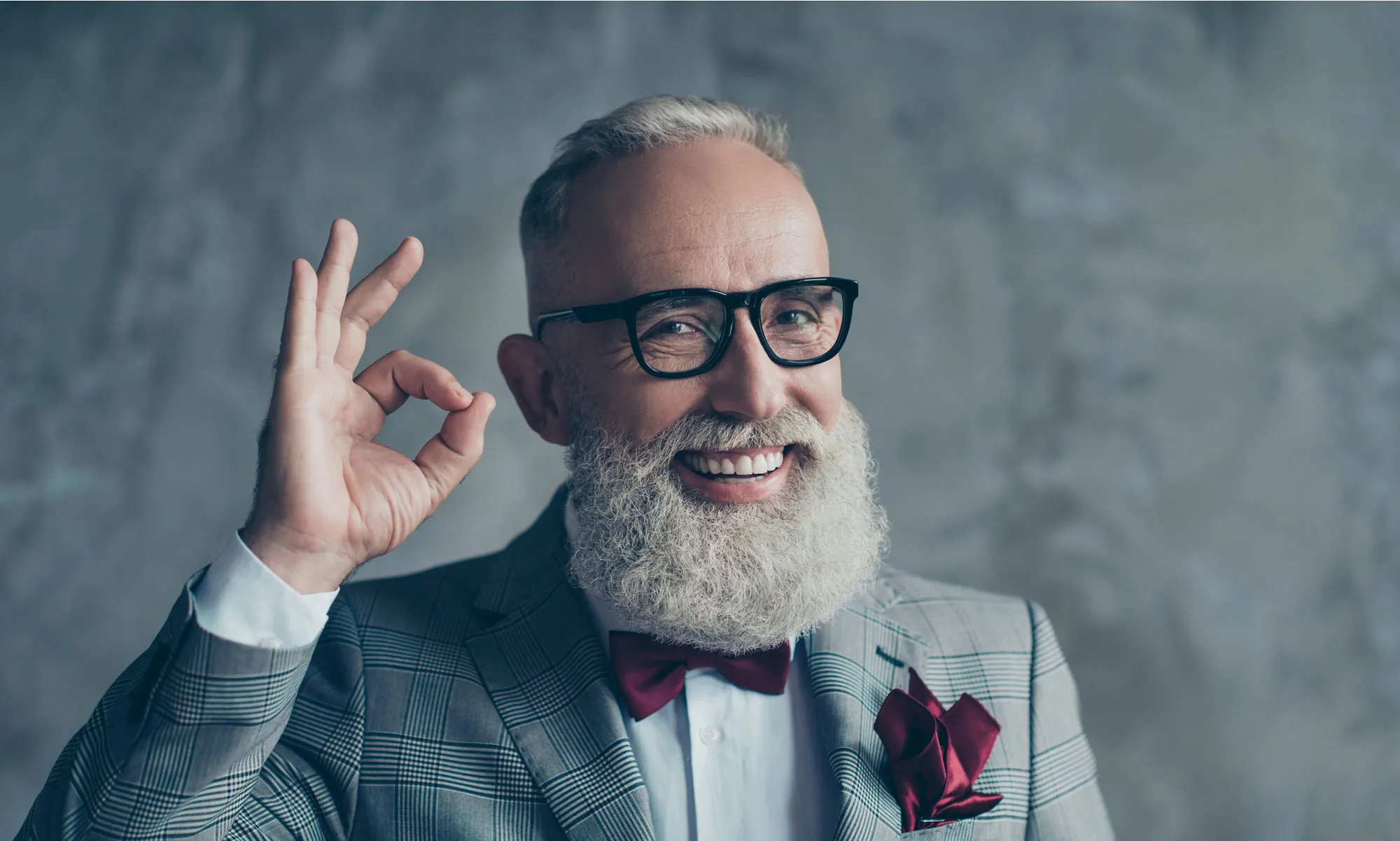 Man in a suit with a beard.