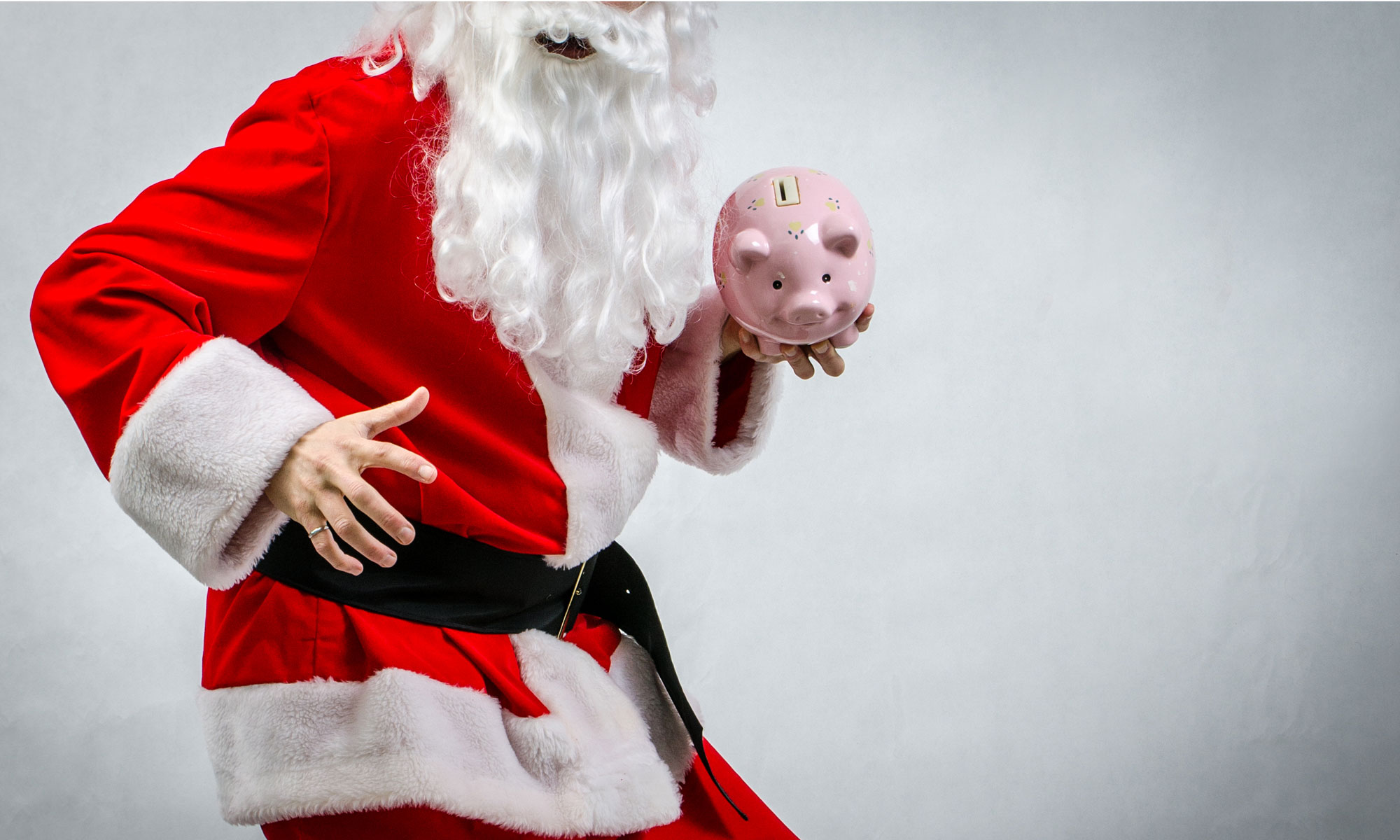 Santa holding a piggy bank