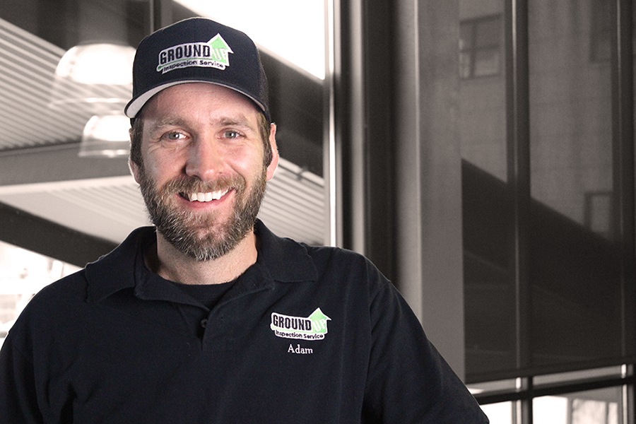 A man in a black shirt with the word 'safety' on it, smiling at the camera.