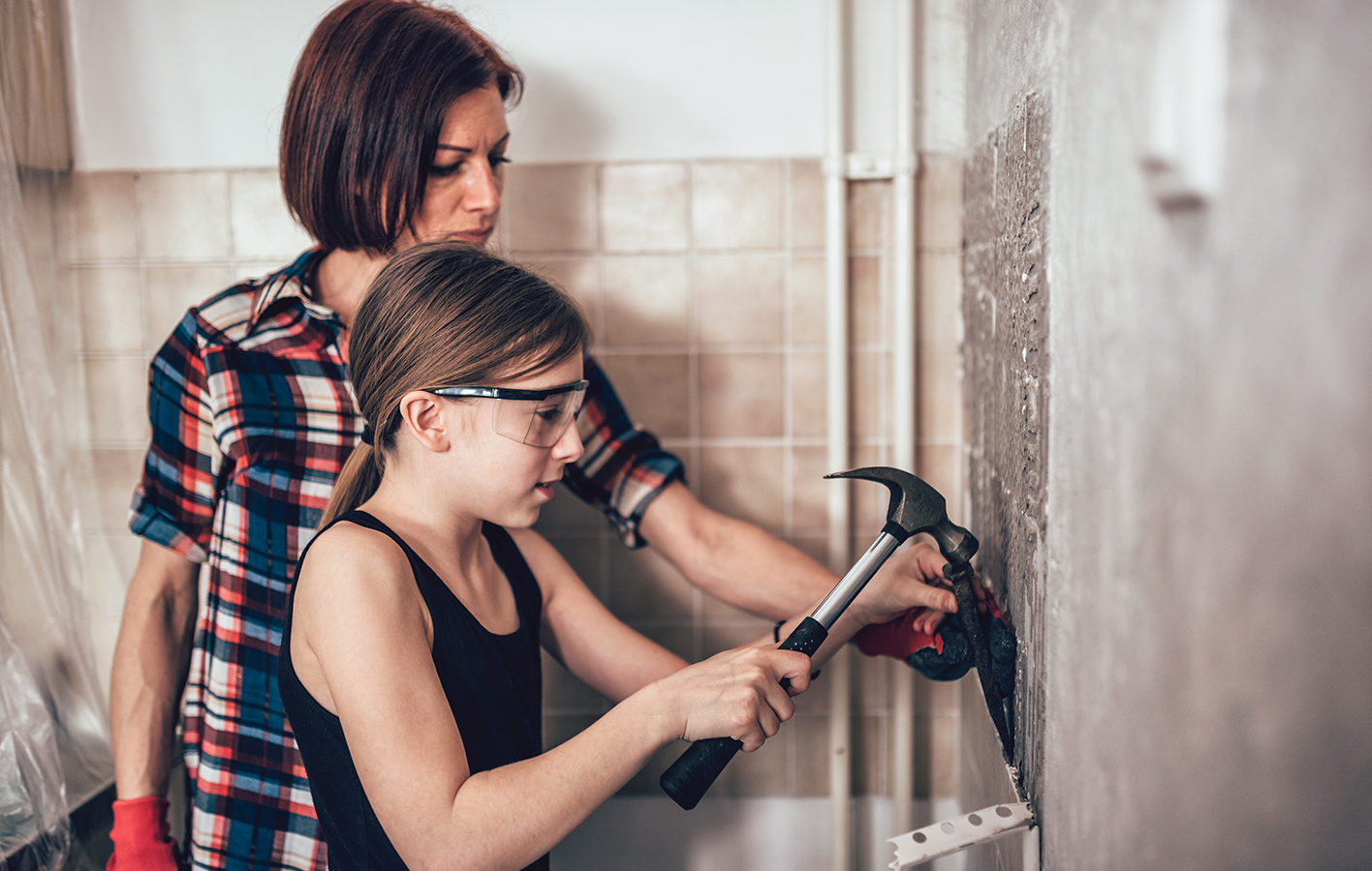 Adult and child working together on home improvement.