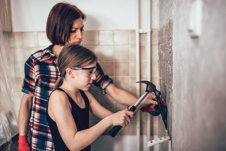 Adult and child working together on home improvement.