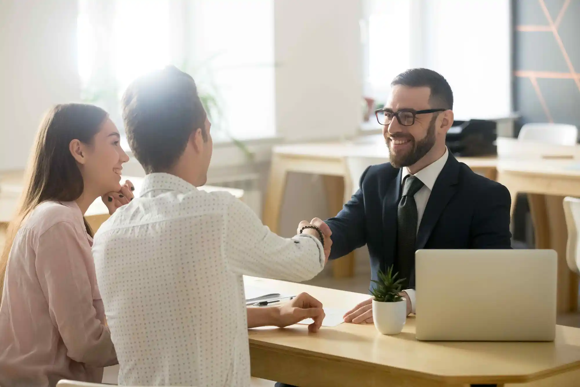 People shaking hands in a professional setting.