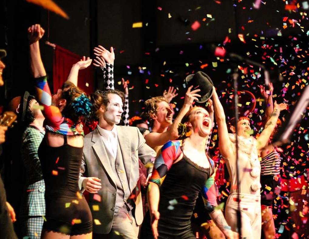 The Bellingham Circus Guild cheering as confetti flies through the air.