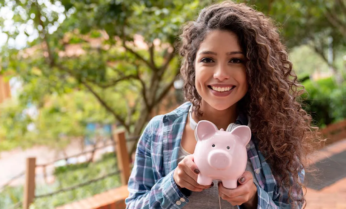 Woman holding a piggy bank.
