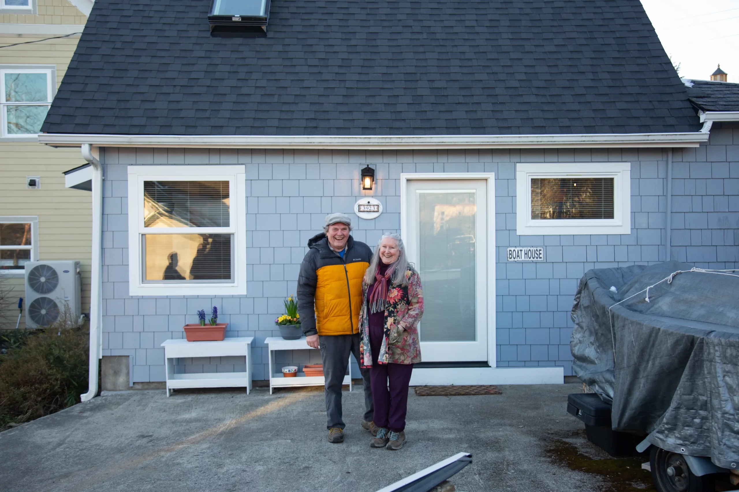 house with two people in front of it