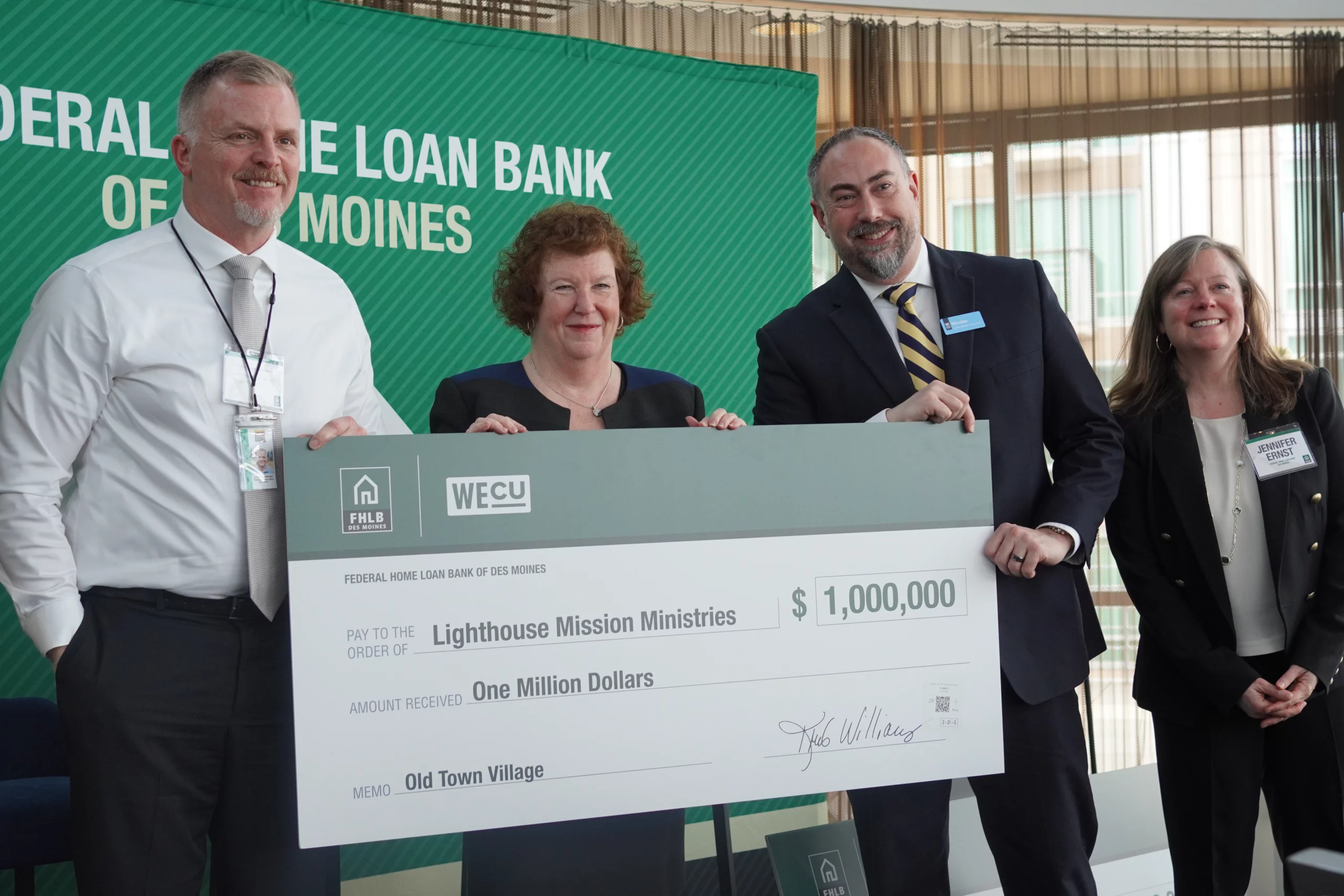group of people behind large check