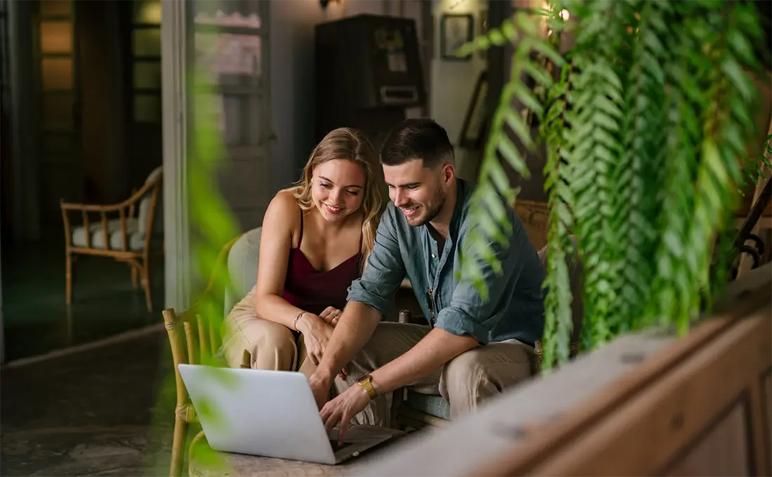 man and woman looking at laptop