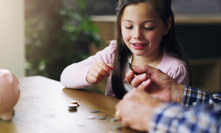 Girl looking at change on table.