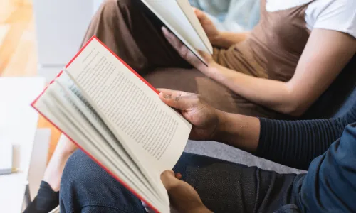 Couple reading books together.