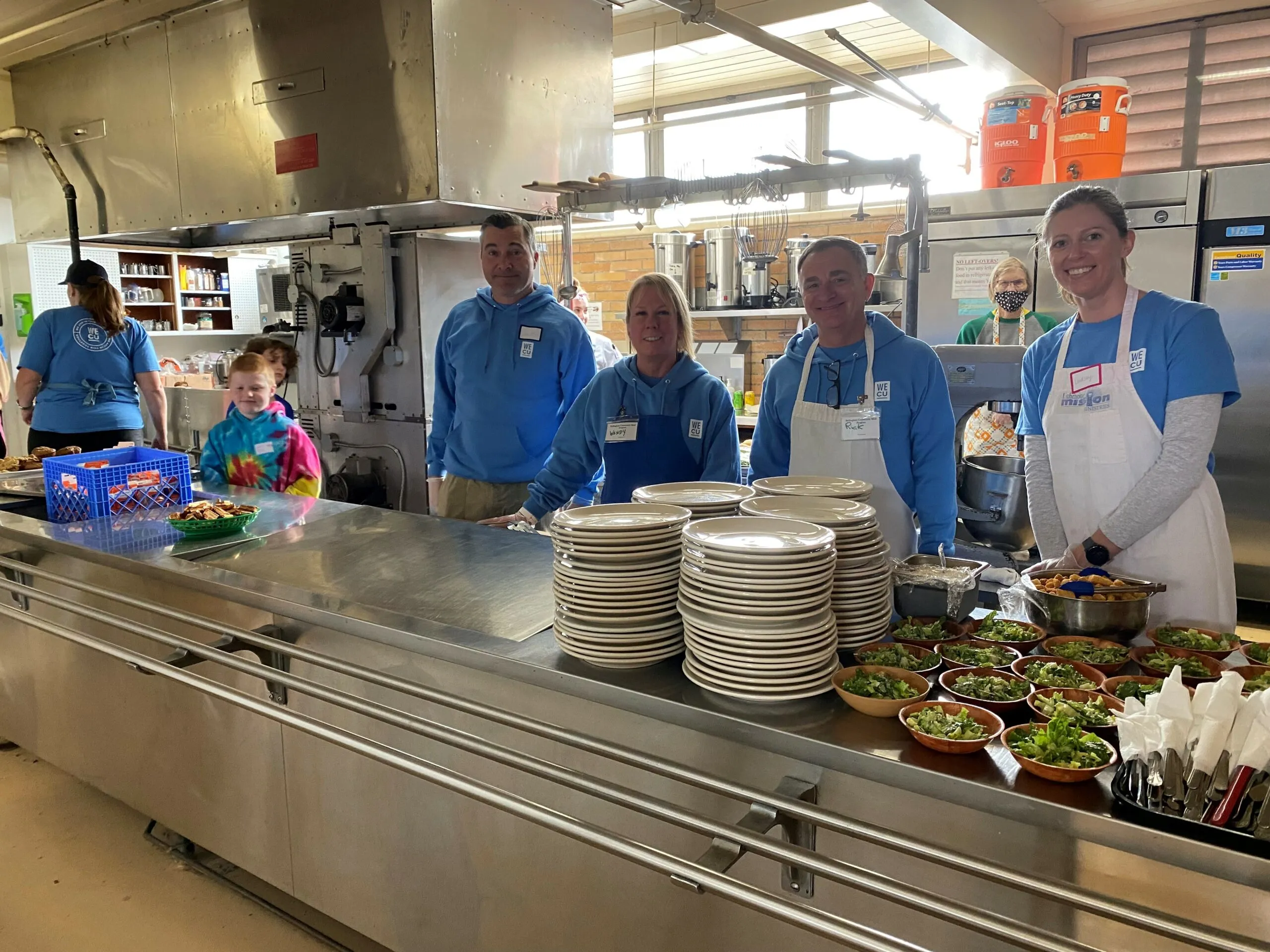 People standing near a buffet table.