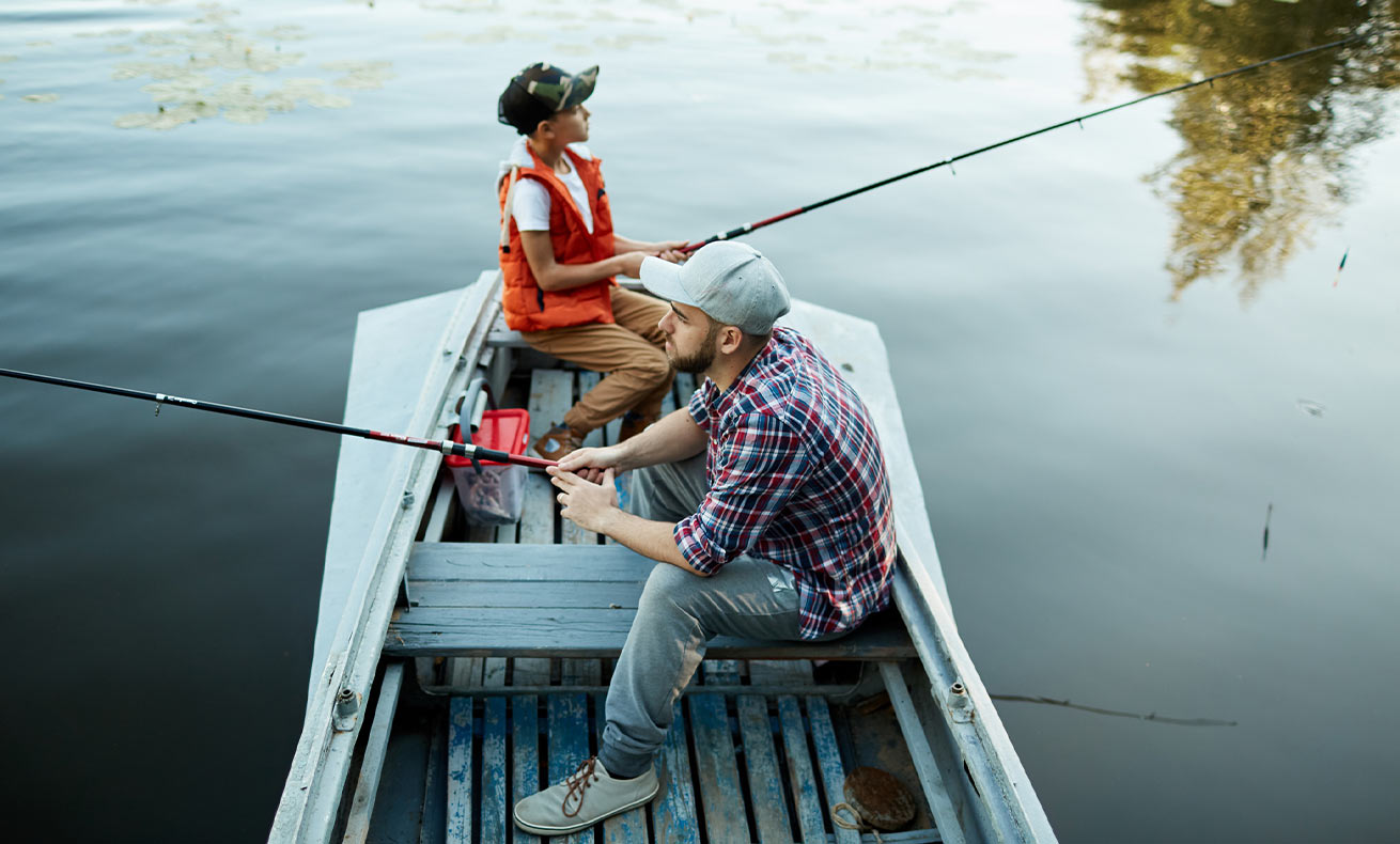 Two people fishing on a boat.