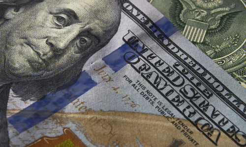 American 20 dollar bill with taped foreign currency.