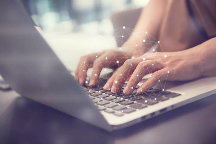 A person typing on a laptop computer.