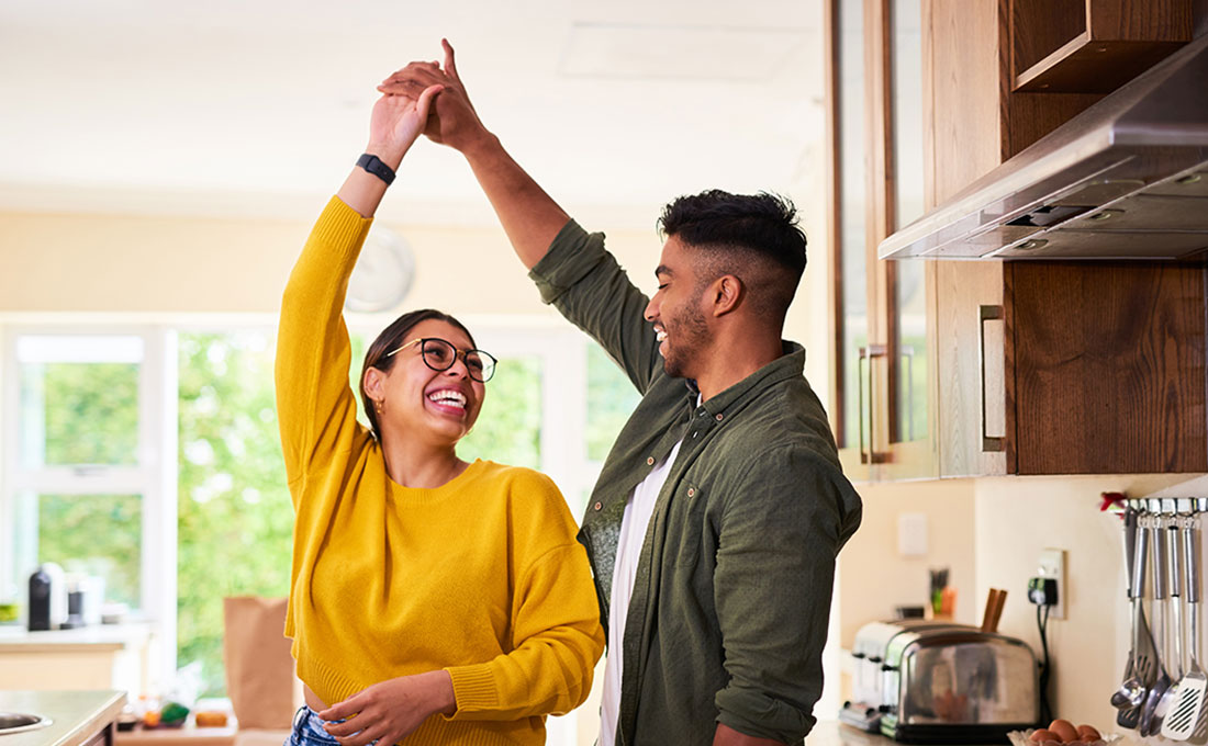 couple dancing in their kitchen