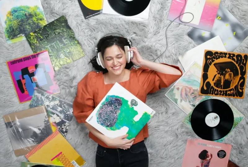 Woman posing with record albums.