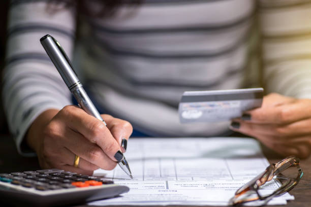 Woman writing on a piece of paper.