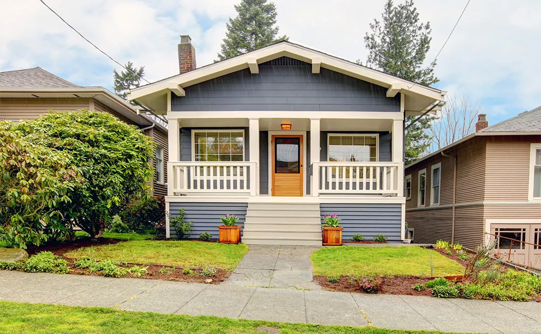 A two-story house with a blue exterior and white trim.