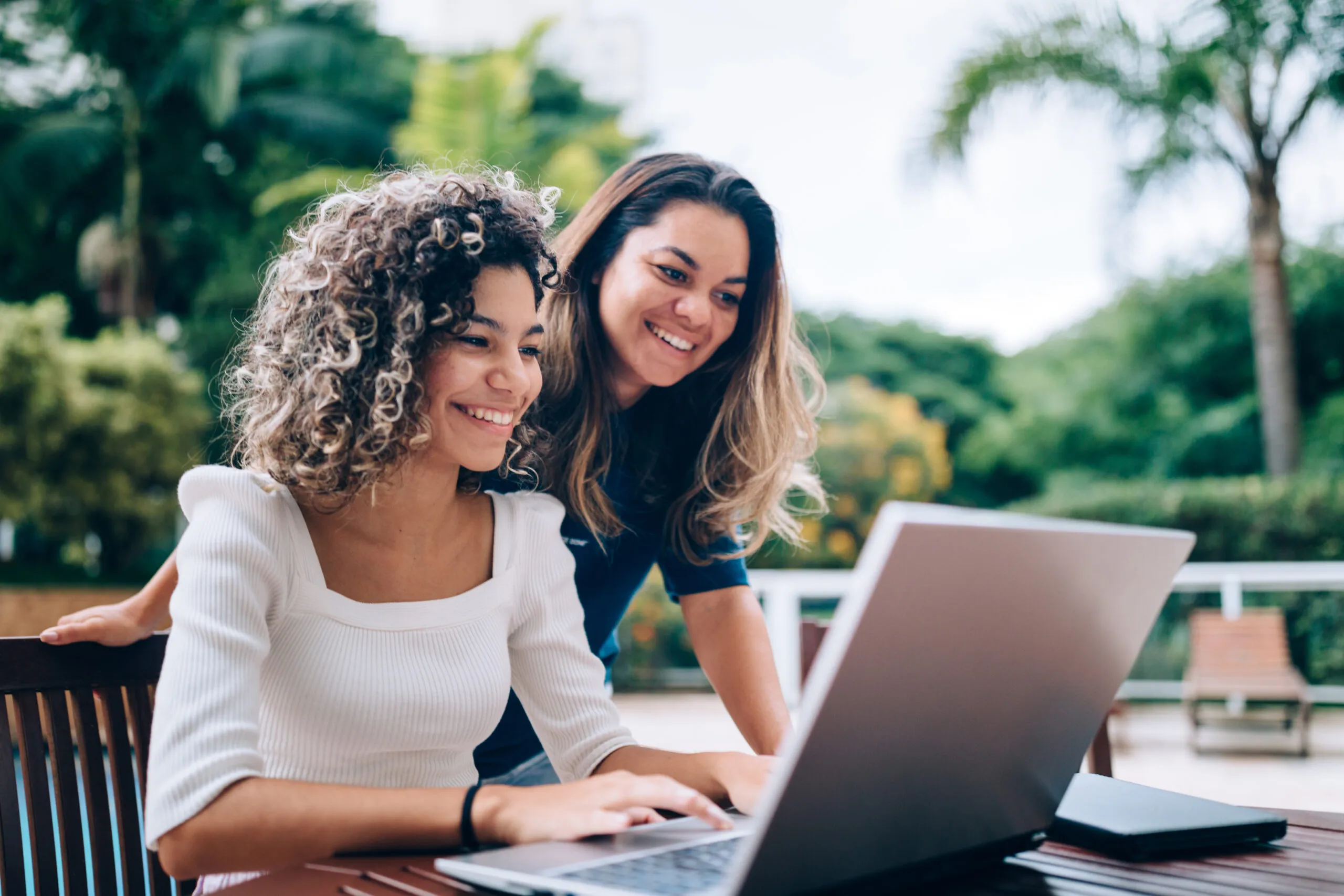 Mother and daughter using laptop
