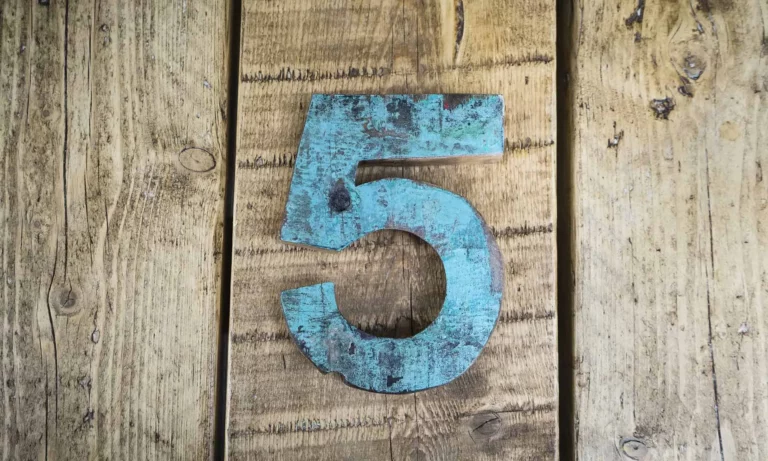Number five sign on wooden surface
