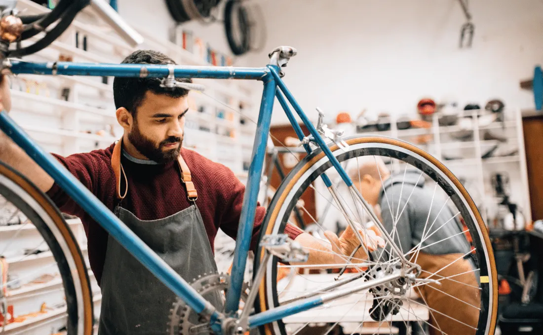 Cyclist working on bicycle.