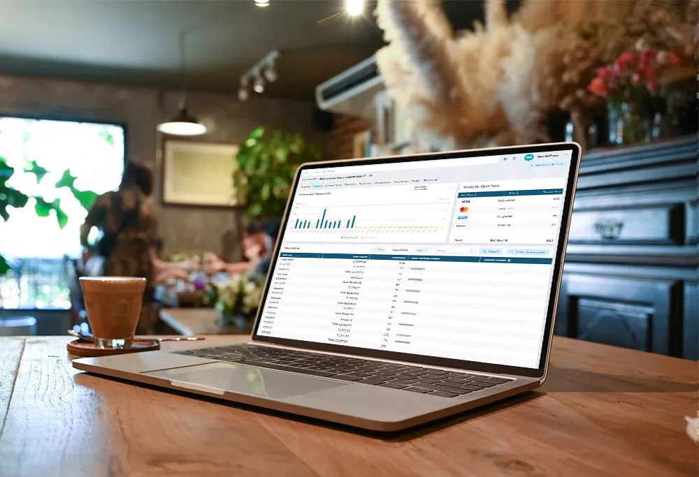 Merchant services app on laptop in cafe