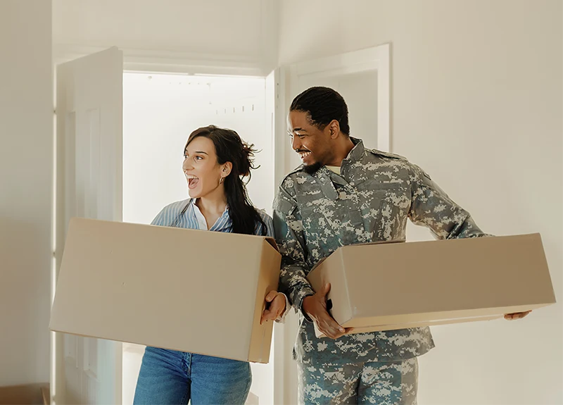 Man and woman carrying boxes.