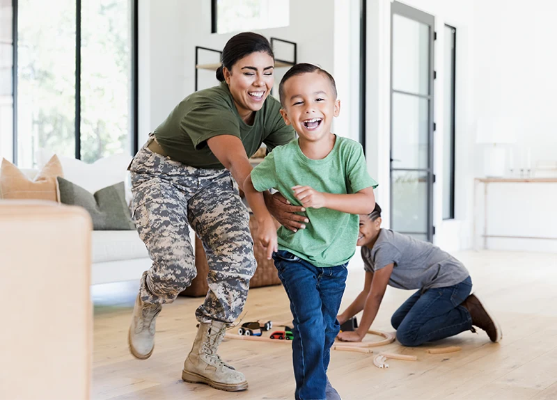 Woman in army uniform with child.