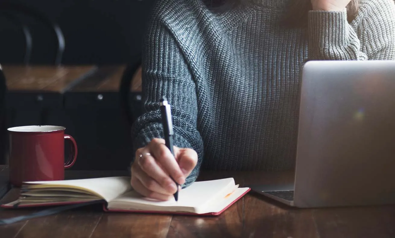 Person writing at a desk