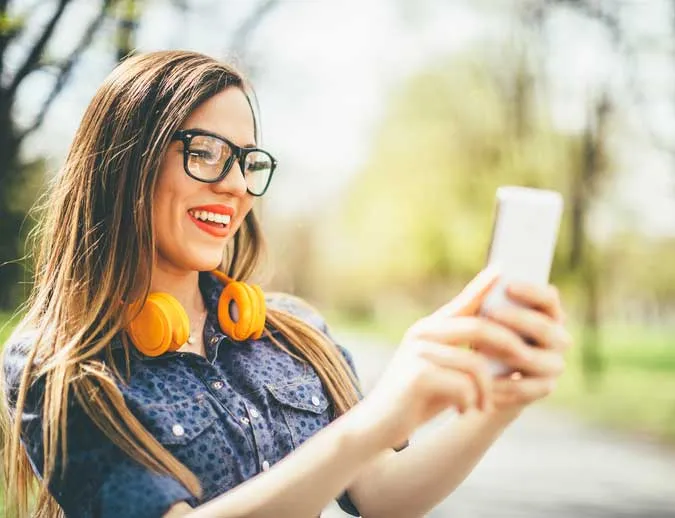 Woman with glasses taking a selfie.