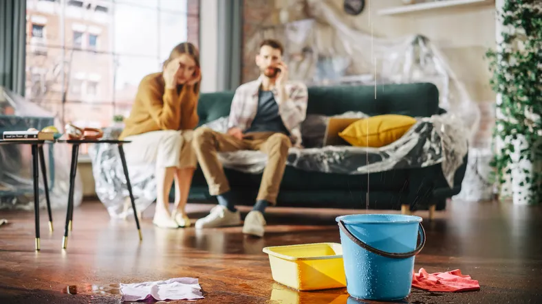 Couple relaxing in a cluttered living room.