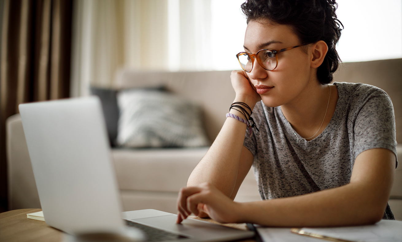 Girl in glasses using a laptop.