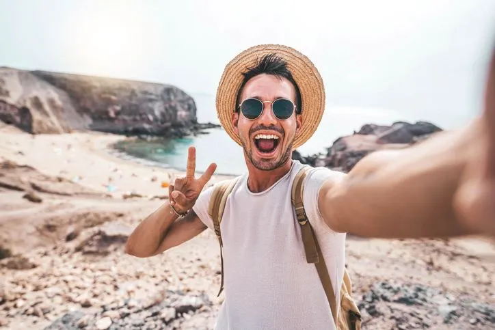 Happy traveler taking a selfie.
