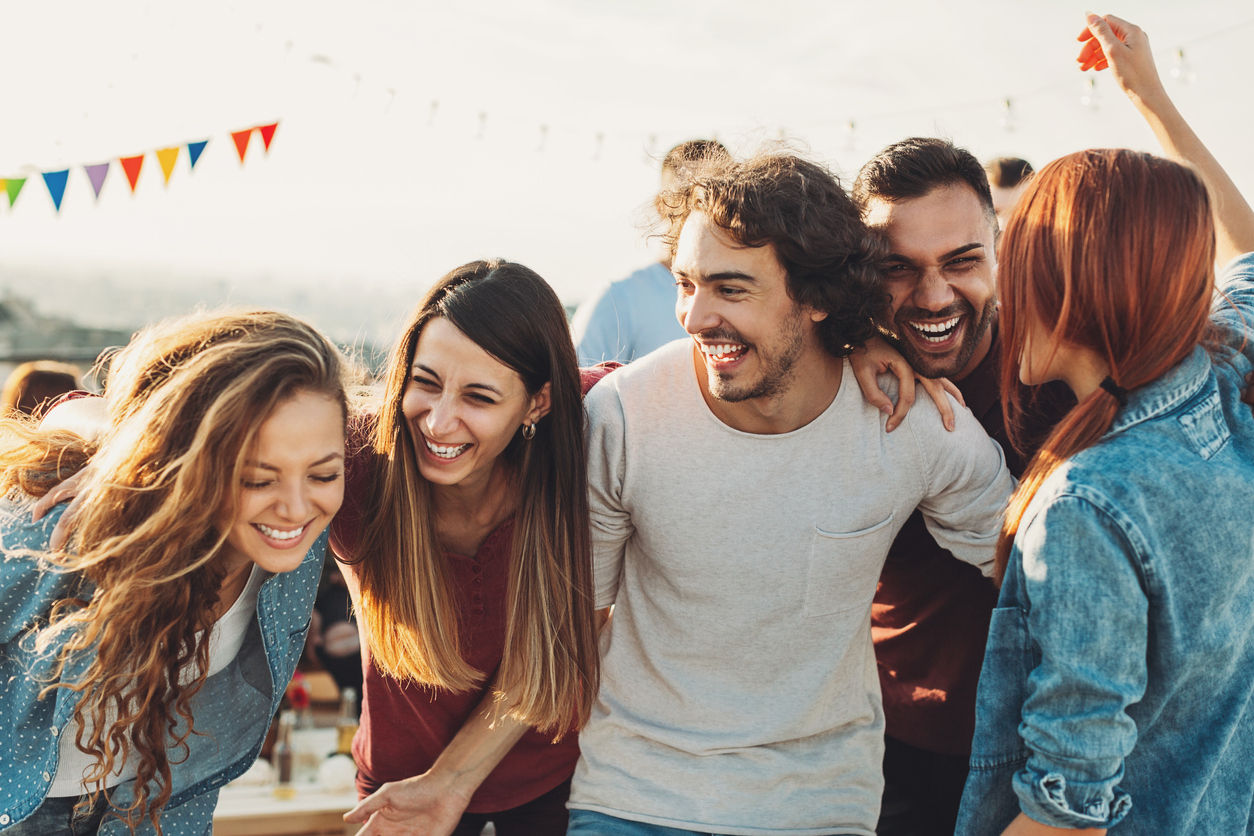group of multi-ethnic young adults partying outside